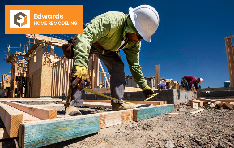 Worker measuring a frame to ensure compliance with building permits